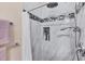 Shower featuring a shower head, marble tiles, and decorative accent tiles at 102 Bayamo Dr, North Port, FL 34287