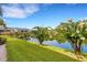 Picturesque backyard view with lush landscaping and tranquil pond creating a peaceful oasis at 1100 Capri Isles Blvd # 215, Venice, FL 34292