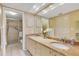 Bathroom featuring double sinks, granite countertop, and walk-in shower at 1100 Capri Isles Blvd # 215, Venice, FL 34292