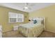 Cozy bedroom with carpet, ceiling fan, and a window that provides natural light at 1100 Capri Isles Blvd # 215, Venice, FL 34292