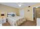 Inviting bedroom featuring a ceiling fan, closet, carpet and a view of the hallway to the next room at 1100 Capri Isles Blvd # 215, Venice, FL 34292