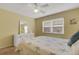 Bedroom featuring a dresser with mirror, carpet and a ceiling fan at 1100 Capri Isles Blvd # 215, Venice, FL 34292