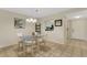 Inviting dining room featuring a glass table, comfortable seating, and convenient kitchen access at 1100 Capri Isles Blvd # 215, Venice, FL 34292