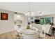 Inviting dining room with a glass table, adjacent to the living area and featuring a built-in bar area at 1100 Capri Isles Blvd # 215, Venice, FL 34292