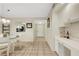 Open-concept dining area with comfortable seating, adjacent kitchen, and easy access to entryway at 1100 Capri Isles Blvd # 215, Venice, FL 34292