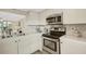 Bright kitchen featuring stainless steel appliances, white cabinets, and modern finishes at 1100 Capri Isles Blvd # 215, Venice, FL 34292