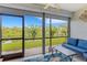 Relaxing lanai with comfortable seating overlooking a beautiful waterfront view and manicured lawn at 1100 Capri Isles Blvd # 215, Venice, FL 34292