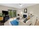 Bright living room featuring a cozy fireplace, comfortable seating, and sliding glass doors offering a view of the outdoors at 1100 Capri Isles Blvd # 215, Venice, FL 34292