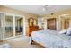 Bright main bedroom featuring sliding glass doors to the lanai at 1100 Capri Isles Blvd # 215, Venice, FL 34292