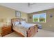 Cozy main bedroom features a ceiling fan and a bright window at 1100 Capri Isles Blvd # 215, Venice, FL 34292