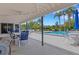 Inviting community pool area with covered seating and ample space for relaxation under the sun at 1100 Capri Isles Blvd # 215, Venice, FL 34292