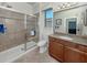 Bathroom featuring granite counters, a walk-in shower and updated fixtures at 11192 Campazzo Dr, Venice, FL 34292