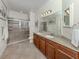 Bathroom featuring double vanity, granite counters, tiled walk-in shower at 11192 Campazzo Dr, Venice, FL 34292