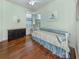 Bedroom featuring hardwood floors, natural light, and a decorative bed frame at 11192 Campazzo Dr, Venice, FL 34292