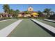 Well-maintained bocce ball court adjacent to the community center and lush landscaping at 11192 Campazzo Dr, Venice, FL 34292