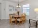 Bright dining room with wooden table, seating for six, and natural light at 11192 Campazzo Dr, Venice, FL 34292