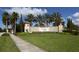 Welcoming entrance to Venetian Falls community, featuring lush landscaping and a decorative sign at 11192 Campazzo Dr, Venice, FL 34292