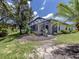 Back exterior shows a covered patio, mature trees, and landscaping at 11192 Campazzo Dr, Venice, FL 34292