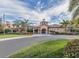 Beautiful clubhouse exterior showcasing manicured lawns, an American flag, and a welcoming entrance at 11192 Campazzo Dr, Venice, FL 34292