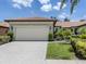 Charming single-story home featuring a tile roof, brick driveway, and well-manicured landscaping at 11192 Campazzo Dr, Venice, FL 34292