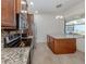 Kitchen with stainless steel appliances, granite countertops, and a central island at 11192 Campazzo Dr, Venice, FL 34292