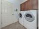 Laundry room equipped with washer, dryer, and cabinetry for storage at 11192 Campazzo Dr, Venice, FL 34292
