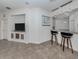 Open living area featuring a modern bar area and a built in entertainment center at 11192 Campazzo Dr, Venice, FL 34292