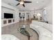 Open-concept living room with tile floors, contemporary decor, and ample natural light at 11192 Campazzo Dr, Venice, FL 34292