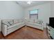 Bright living room features hardwood floors, neutral paint, and two sofas at 11192 Campazzo Dr, Venice, FL 34292