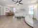 Spacious living room with plush sofa, glass coffee table, and views of the dining area at 11192 Campazzo Dr, Venice, FL 34292