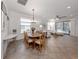 Open-concept living and dining area with tile flooring, natural light, and access to the patio at 11192 Campazzo Dr, Venice, FL 34292