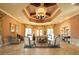 Elegant community lounge area with a decorative ceiling, ornate chandelier, and comfortable seating at 11192 Campazzo Dr, Venice, FL 34292
