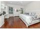 Spacious main bedroom featuring hardwood floors and two windows at 11192 Campazzo Dr, Venice, FL 34292