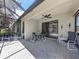 Screened-in patio with brick flooring, ceiling fan, and ample seating for outdoor entertaining at 11192 Campazzo Dr, Venice, FL 34292