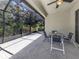 Screened-in patio with tile flooring has outdoor seating and a ceiling fan at 11192 Campazzo Dr, Venice, FL 34292