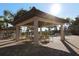 Shaded poolside pavilion with comfortable seating, perfect for outdoor dining and socializing at 11192 Campazzo Dr, Venice, FL 34292