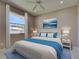 This staged bedroom has light colored walls, tile flooring, a ceiling fan, and a nice window view at 1136 Deardon Dr, Venice, FL 34292