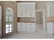 Breakfast nook with transom windows and views into the home, along with custom white cabinetry at 1136 Deardon Dr, Venice, FL 34292