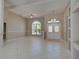 This is a well-lit foyer with a tile floor and an arched window near the front door at 1136 Deardon Dr, Venice, FL 34292