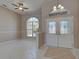 This tan foyer features double doors with a stained-glass design and an arched window at 1136 Deardon Dr, Venice, FL 34292