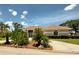 A single-story home with desert-style landscaping and a red tile roof under a blue sky with white clouds at 1136 Deardon Dr, Venice, FL 34292