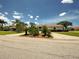 A single-story home with desert-style landscaping and a red tile roof under a blue sky with white clouds at 1136 Deardon Dr, Venice, FL 34292