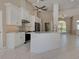 Bright kitchen featuring stainless steel appliances, white cabinets, and a center island at 1136 Deardon Dr, Venice, FL 34292
