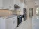 Modern kitchen equipped with stainless steel appliances, sleek cabinets, and marble countertops at 1136 Deardon Dr, Venice, FL 34292