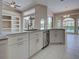 Kitchen with marble countertops, stainless steel appliances, and tile flooring, offering a modern aesthetic at 1136 Deardon Dr, Venice, FL 34292