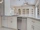 Bright kitchen with marble countertops, stainless steel dishwasher, tile floors, and open layout to dining area at 1136 Deardon Dr, Venice, FL 34292