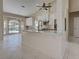 Kitchen island with eat-in bar and updated white cabinets, tile flooring, and views of the pool at 1136 Deardon Dr, Venice, FL 34292