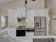 Modern kitchen featuring stainless steel appliances, including a refrigerator, oven, and range hood at 1136 Deardon Dr, Venice, FL 34292
