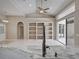 Spacious kitchen featuring tile floors, marble counters, built-in shelving and vaulted ceilings at 1136 Deardon Dr, Venice, FL 34292