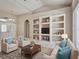 This living room features tile floors, neutral walls, and white furniture at 1136 Deardon Dr, Venice, FL 34292